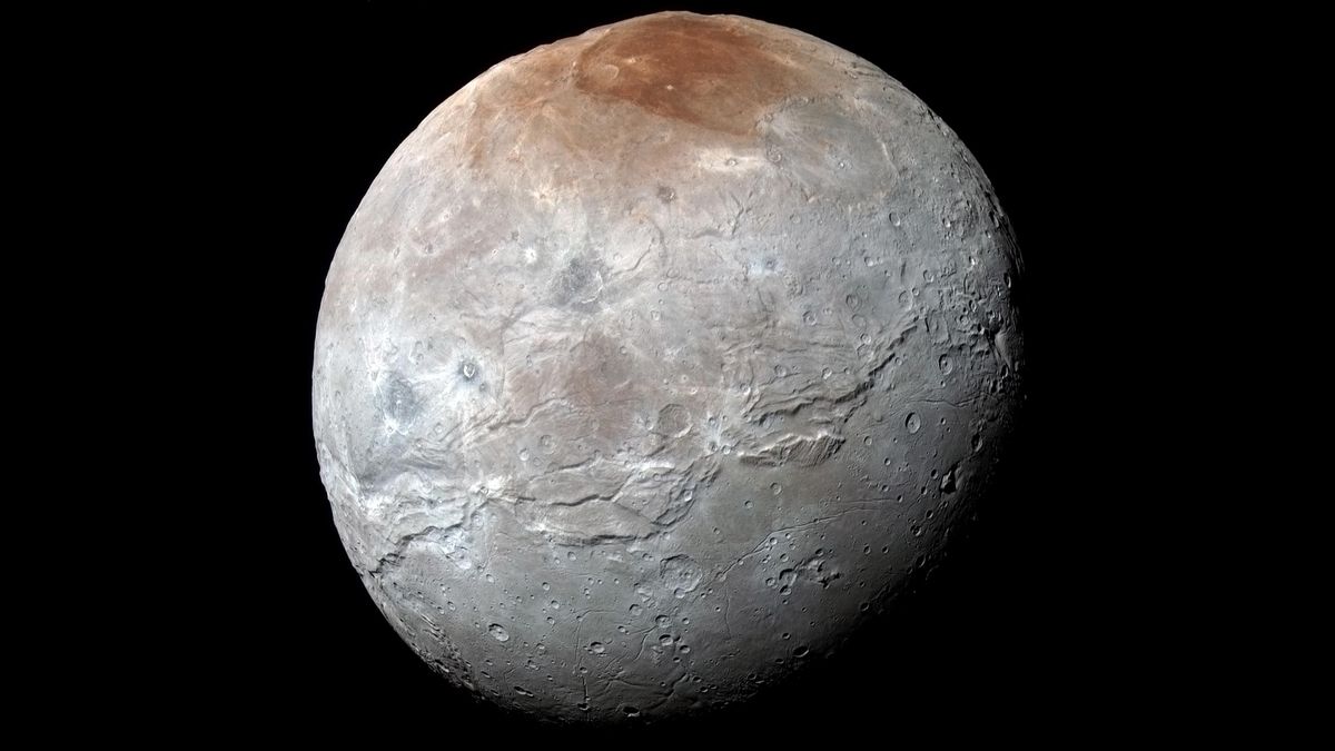 a grey sphere peppered with craters and a distinct rusty red surface at the north pole.