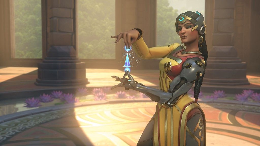 Symmetra stands, presenting a shape made of blue light energy