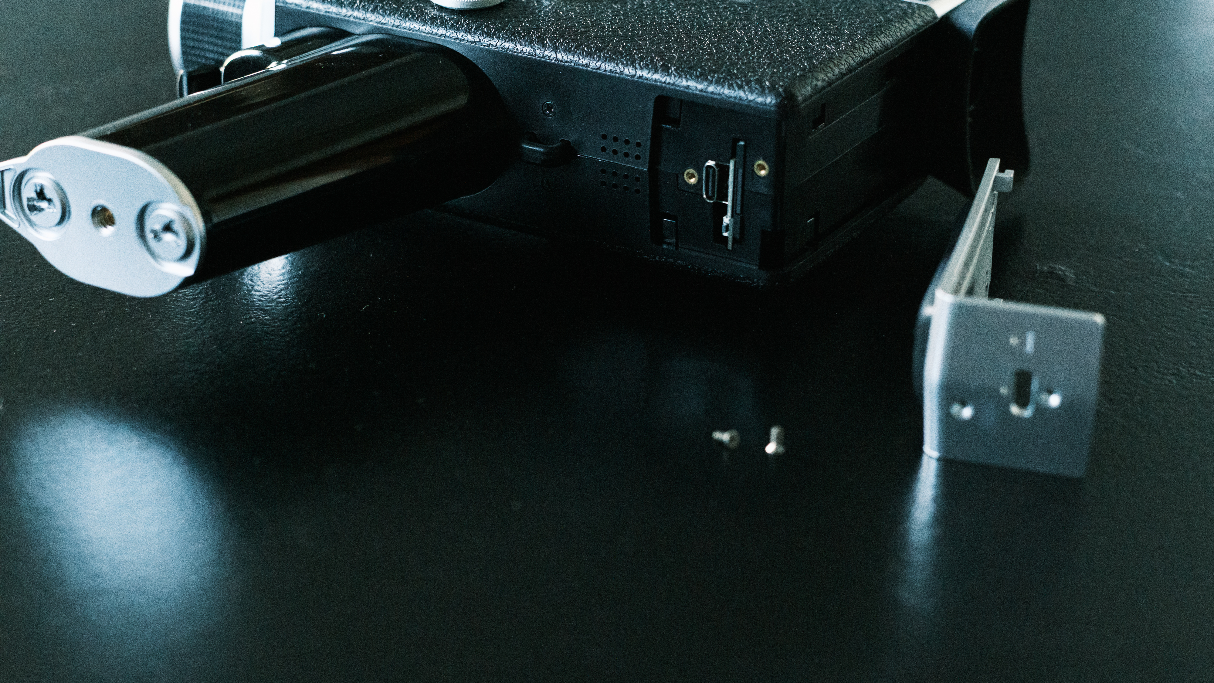 The SD card slot requires removing two small screws to access