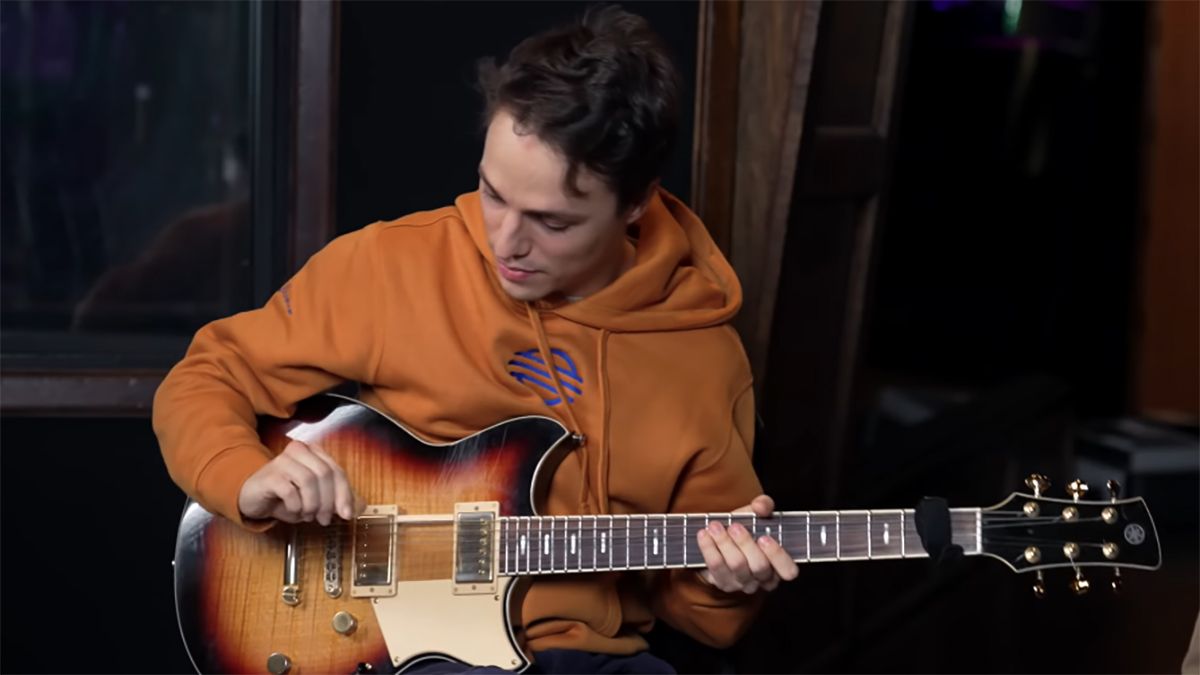 Matteo Mancuso holding a guitar pick