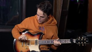 Matteo Mancuso holding a guitar pick