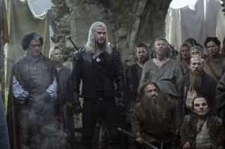 Regis, Geralt, Zoltan, Yarpin, and Percival in a crowd of local color