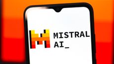 The Mistral AI logo shown on a phone, against an orange and red background.