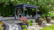pergola on patio with gravel landscaping and fountains