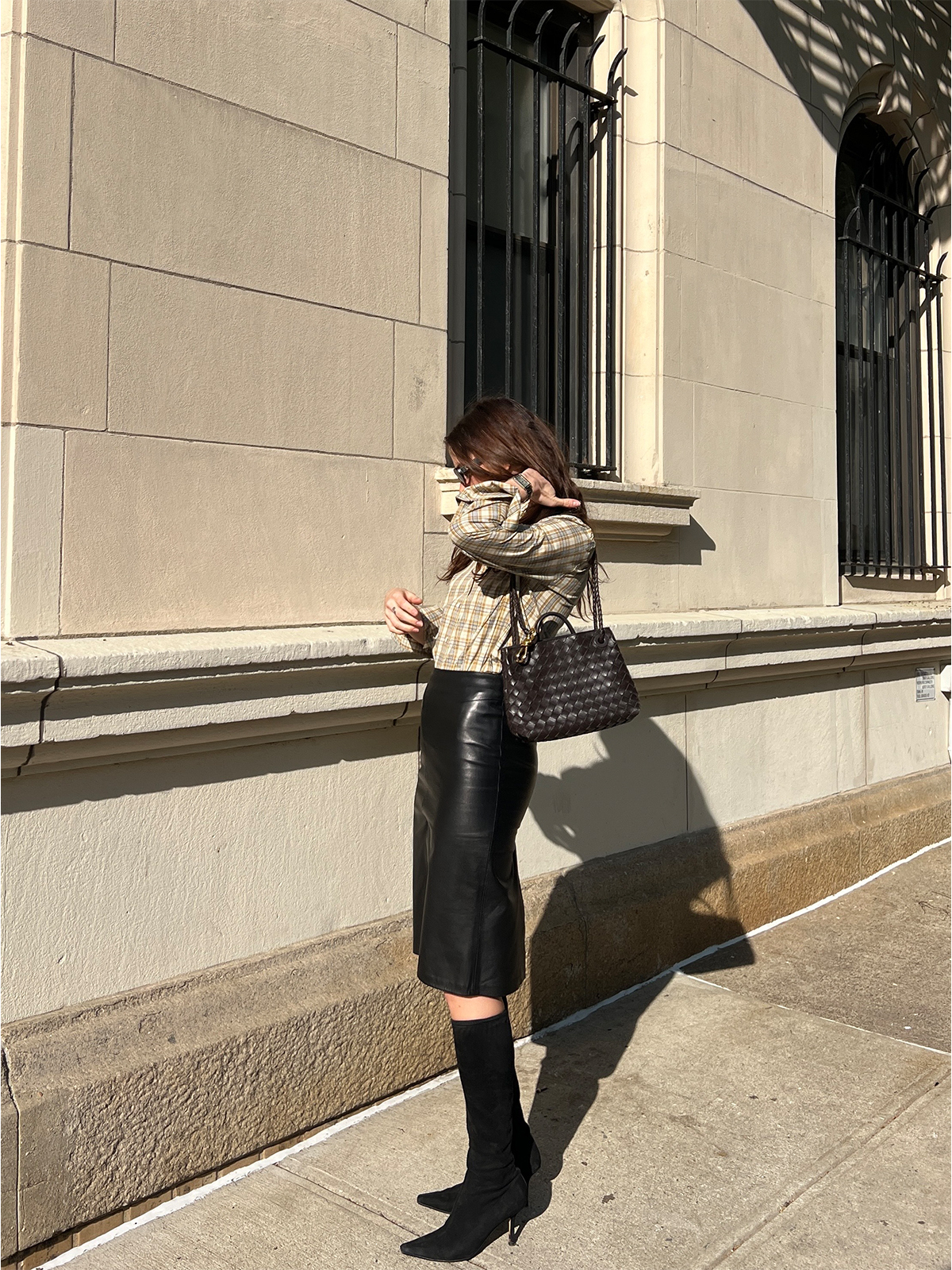 Eliza Huber wearing a tan Tory Burch plaid shirt with a leather Tom Ford for Gucci pencil skirt.