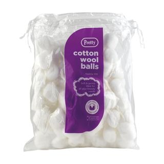 Plastic bag full of cotton wood balls on a white background