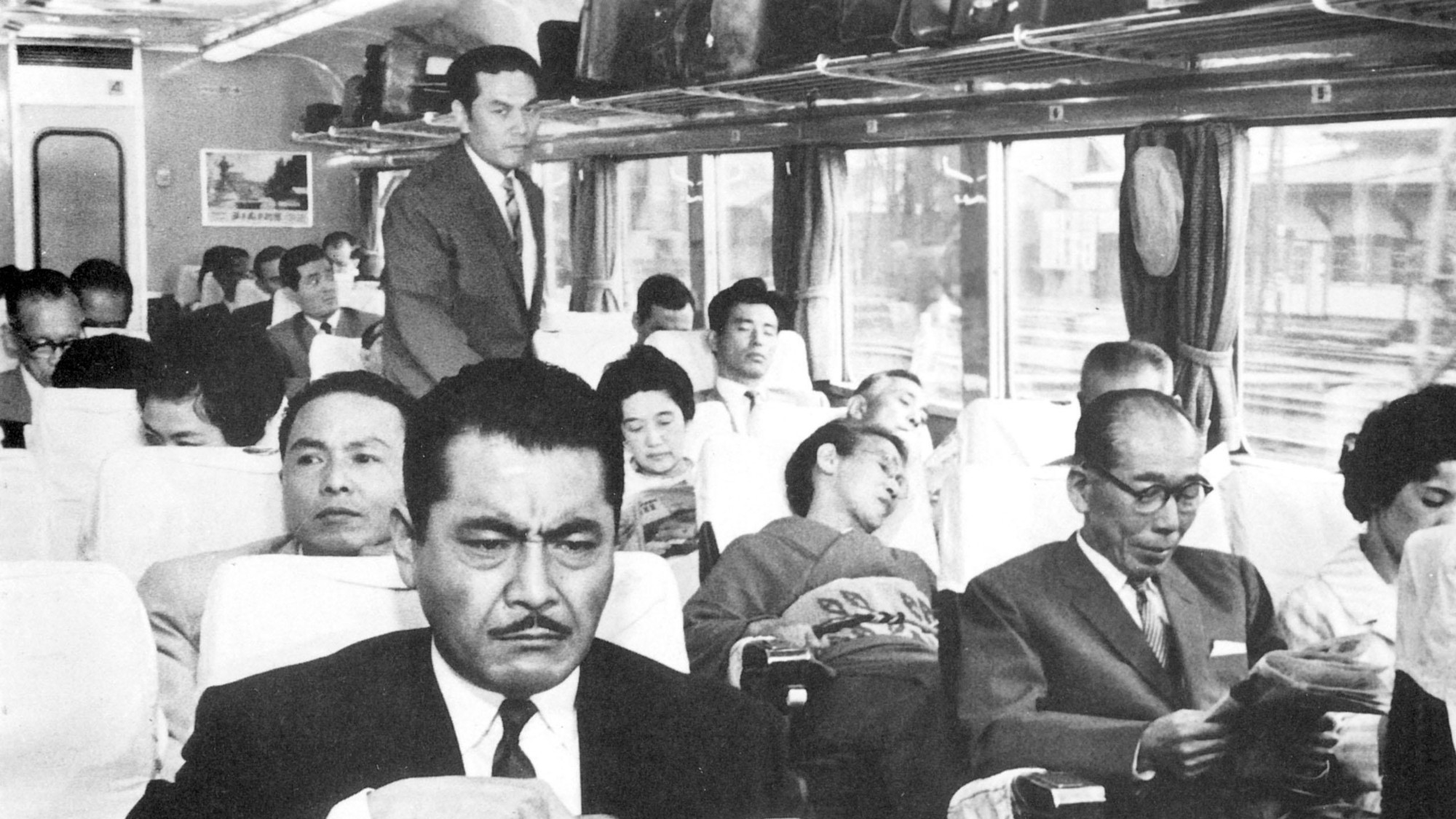 Toshirô Mifune sitting on a crowded train in High and Low