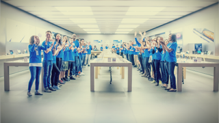 Apple staff cheer at the Apple Store