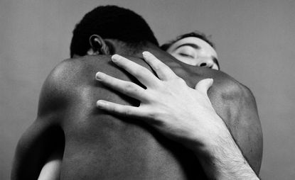 black and white men hugging 