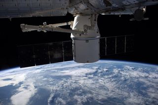 An unmanned SpaceX Dragon capsule is seen docked to the International Space Station shortly after arriving on Sept. 23, 2014. NASA astronaut Reid Wiseman captured this photo from inside the orbiting lab.