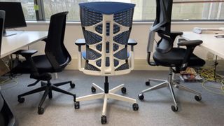 The back of the blue ErgoChair in an office.