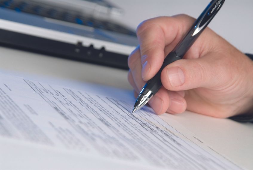 A person signing a form