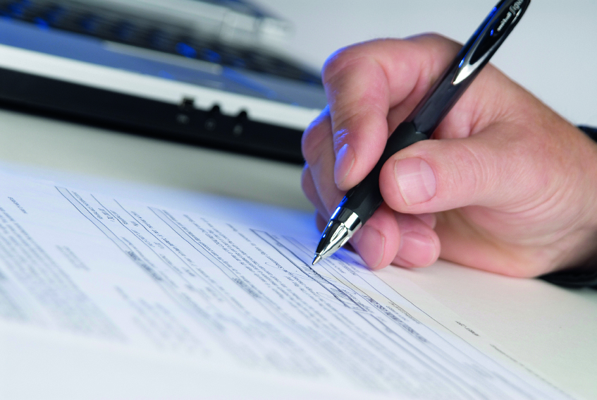 A person signing a form
