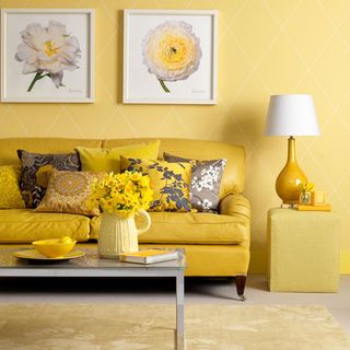 yellow living room with wall frame and table lamp