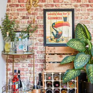 Alcove with brick style wallpaper and bar cart