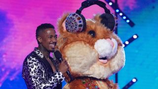 The Hamster standing with Nick Cannon