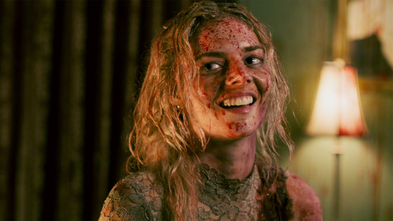 Samara Weaving as Grace laughing and covered in blood in Ready Or Not