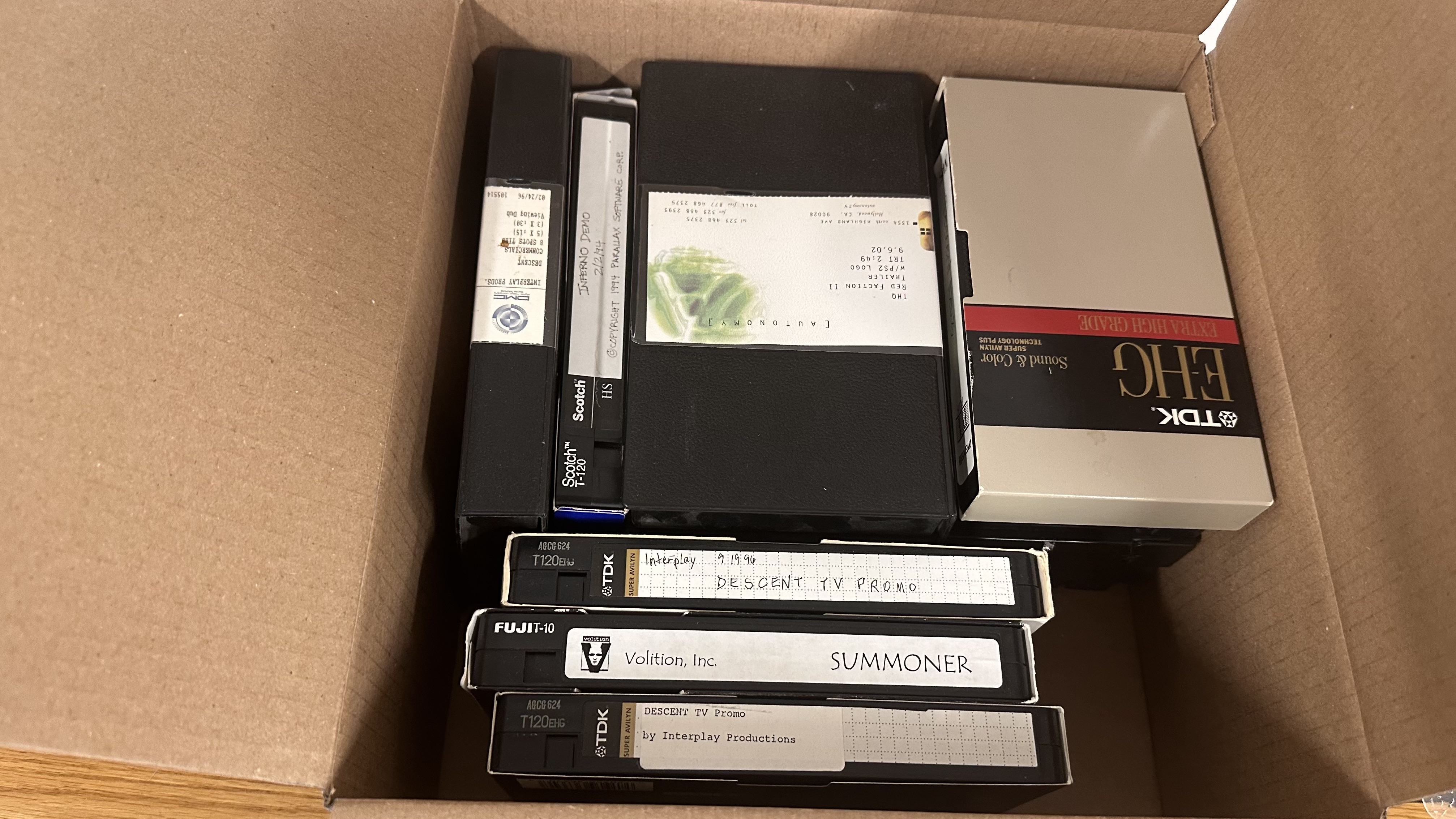A photo shows a box full of VHS tapes belonging to the developer Volition