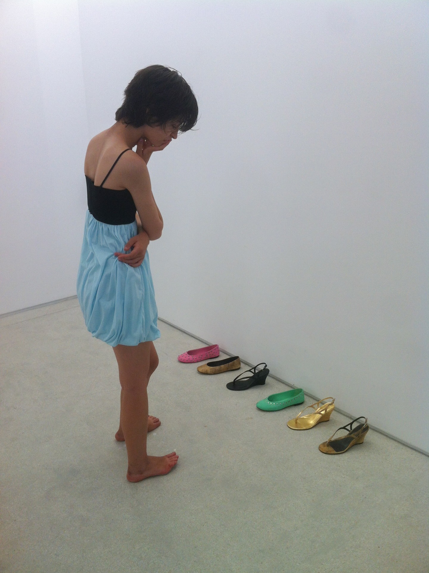 A model looking at a lineup of Gimaguas shoes.