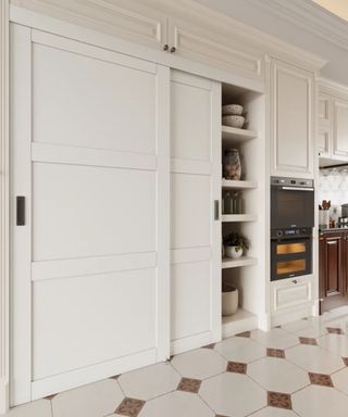 white kitchen with traditional tiled floor and a large cupboard with sliding doors