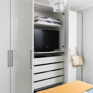 Grey bedroom modular wardrobe, with a TV hidden inside it.