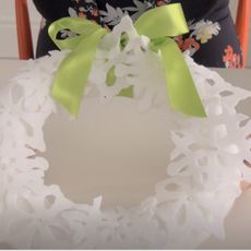 white coloured snowflake with green ribbon