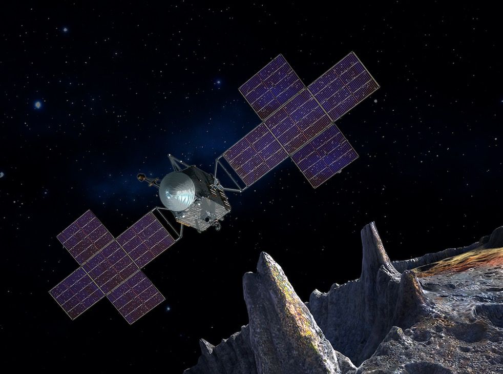 Artist&#039;s illustration of NASA&#039;s Psyche spacecraft near the metallic asteroid 16 Psyche.