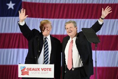 US President-elect Donald Trump (L) and Louisiana Treasurer and Republican Senate candidate John Kennedy wave at a get-out-the-vote rally on December 9, 2016 in Baton Rouge, Louisiana