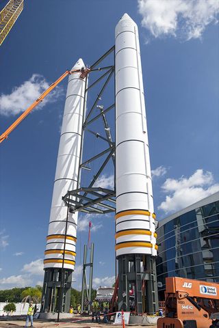 Solid rocket booster replicas are topped with nose cones outside the Space Shuttle Atlantis exhibit at the Kennedy Space Center Visitor Complex in Florida.