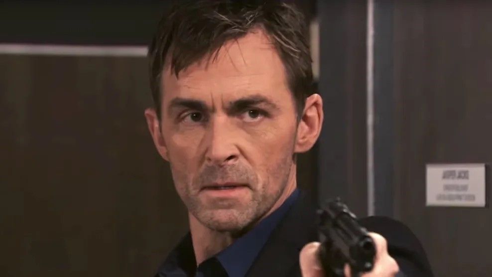 James Patrick Stuart as Valentin holding a gun in General Hospital