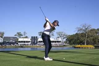 Danny Walker hits his tee shot at the par-3 17th hole at TPC Sawgrass' Stadium Course during round one of the 2025 Players Championship