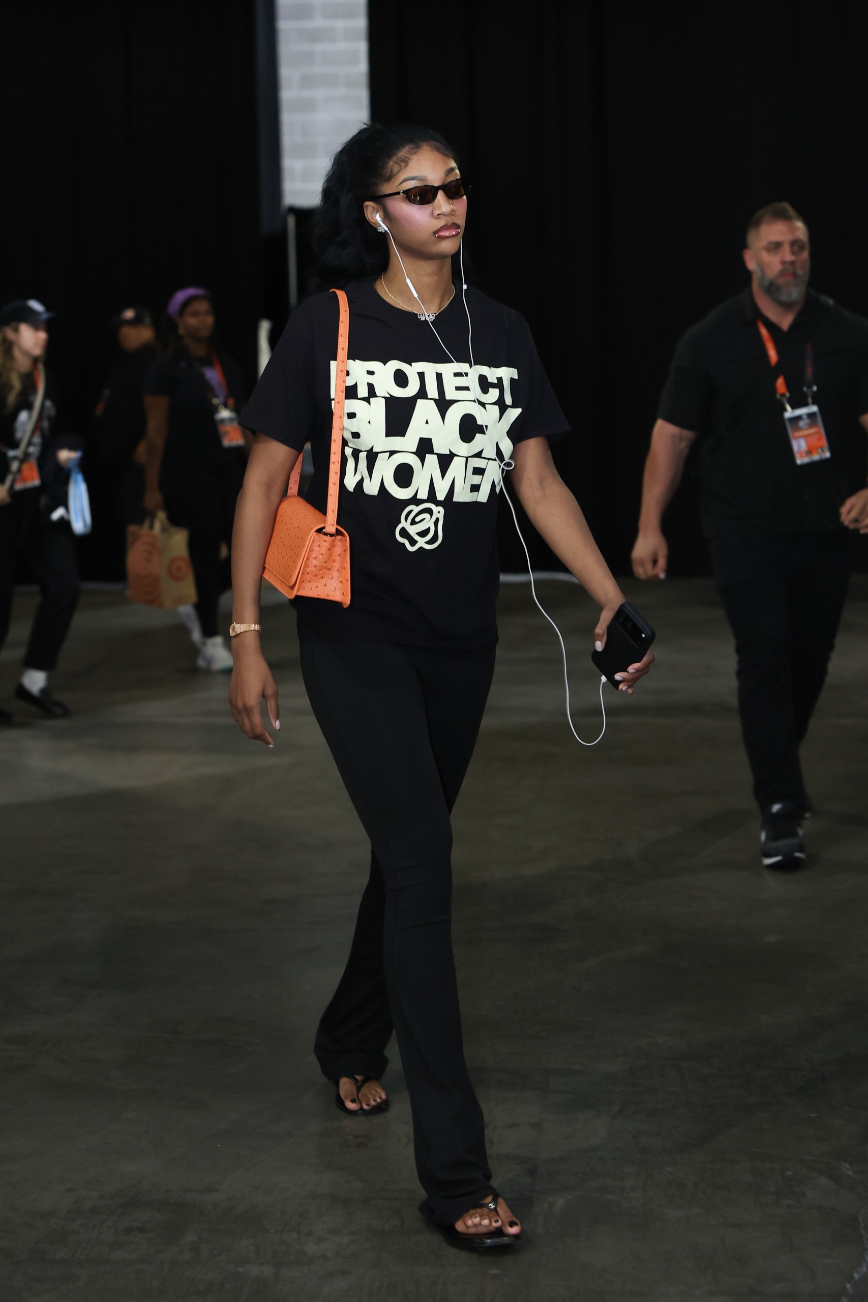 Angel Reese arrived at Game 5 of the WNBA Finals in a Protect Black Women T-shirt and Jordyn Woods's &amp;quot;lucky&amp;quot; orange New York Knicks bag