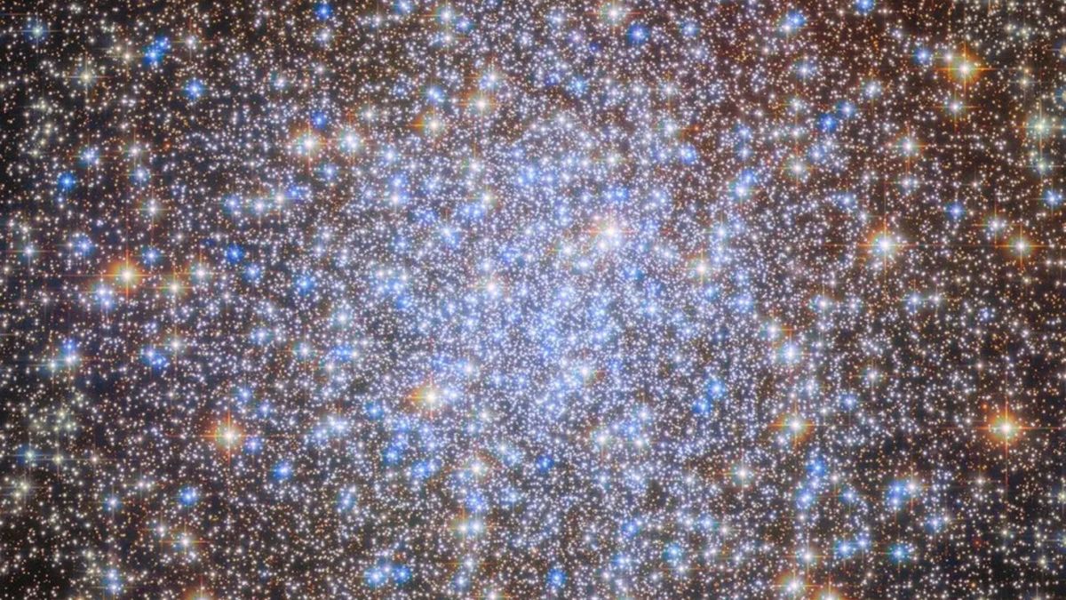 A starfield with bright stars in blue, white, yellow and orange.