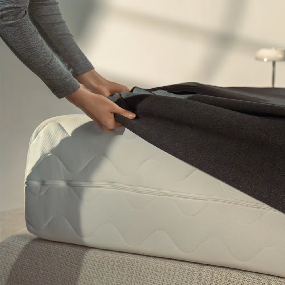 Hands putting eight sleep on mattress