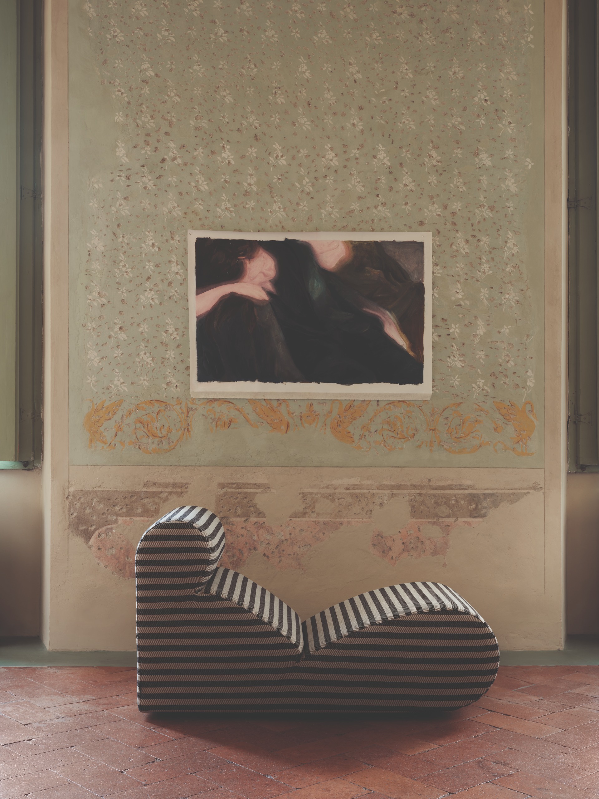 A striped abstract armchair in front of a wall with an abstract poster
