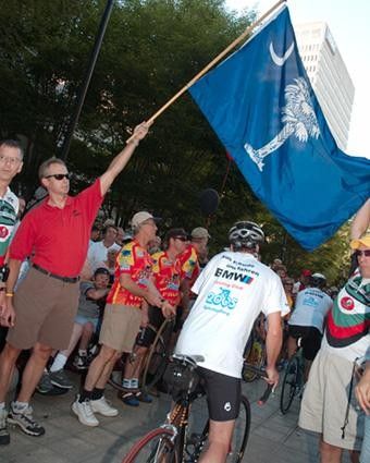 Parade participants ride under the South Carolina flag