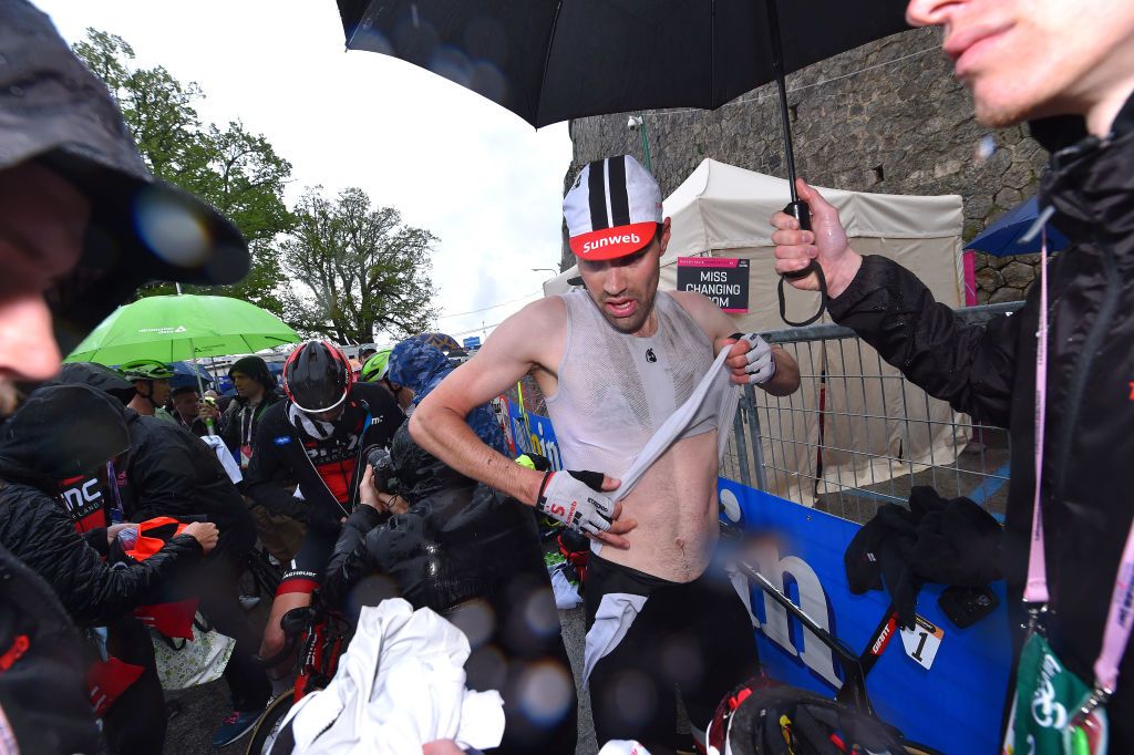 Tom Dumoulin (Sunweb) changes out of his wet kit after a rainy finish