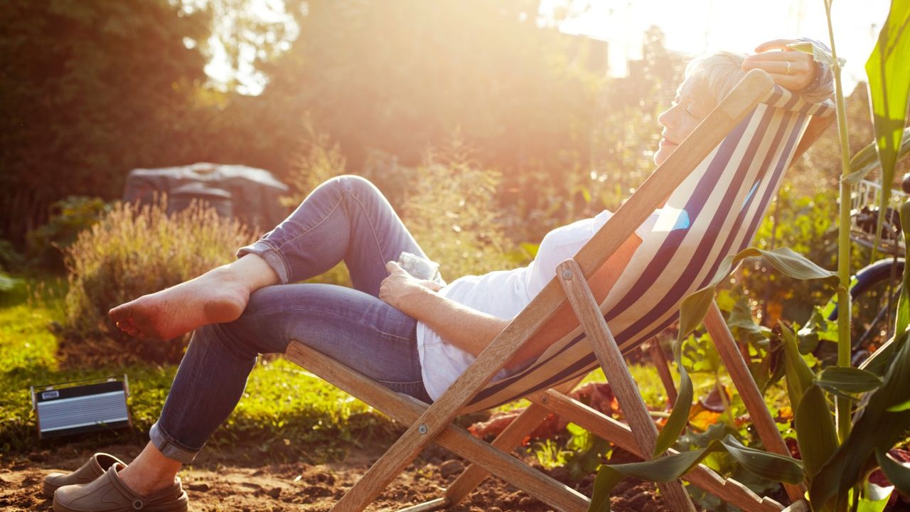 Woman sitting on deckchair in the sun