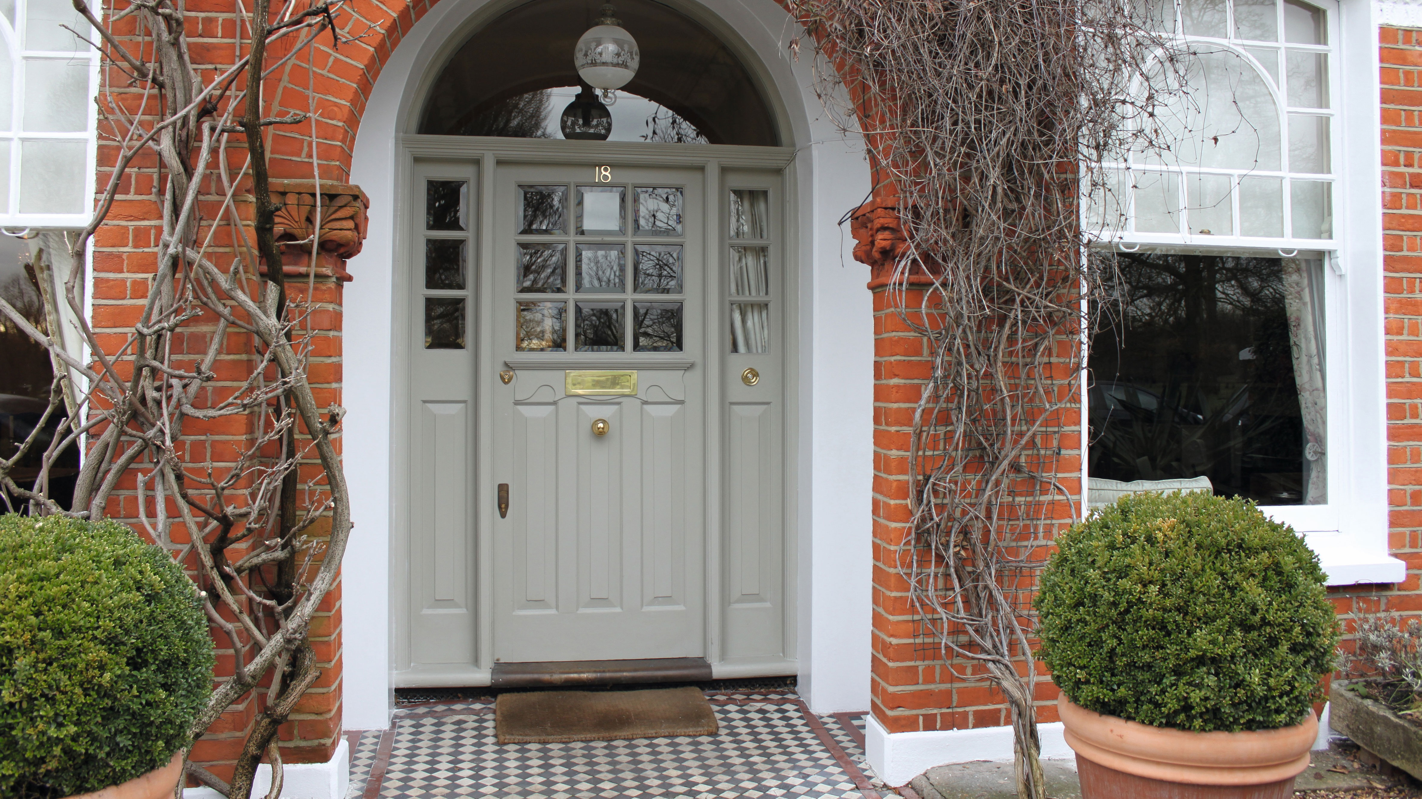 Green Front Door with Painted Striped Stairs - Blushing Bungalow