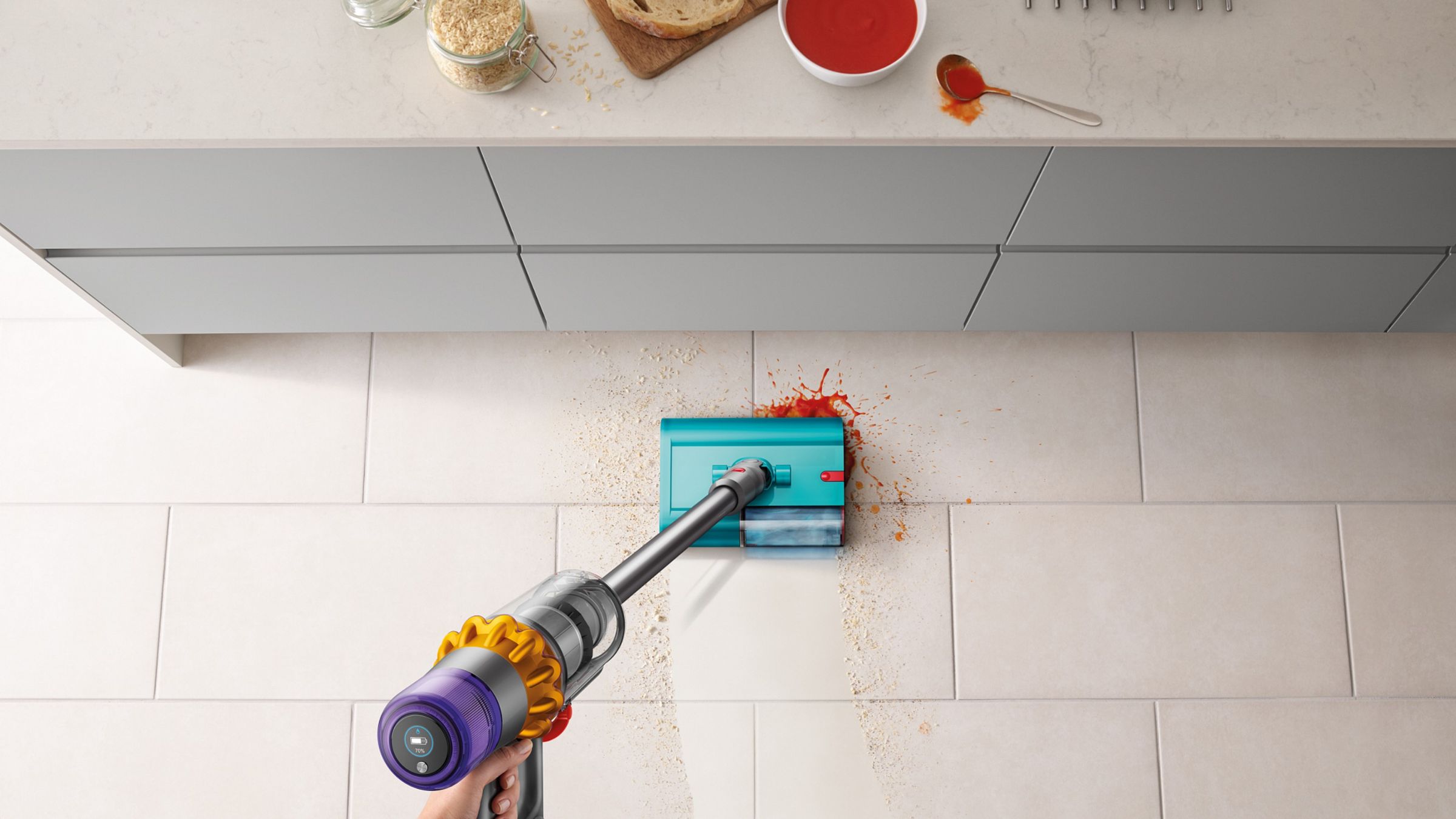 Dyson V15 wet and dry cleaning hard flooring covered in dry and wet debris