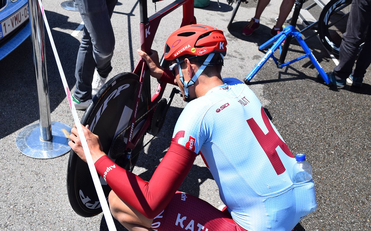 Katusha-Alpecin's Nils Politt checks his tyrees ahead of recon