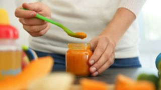 Woman serving baby food