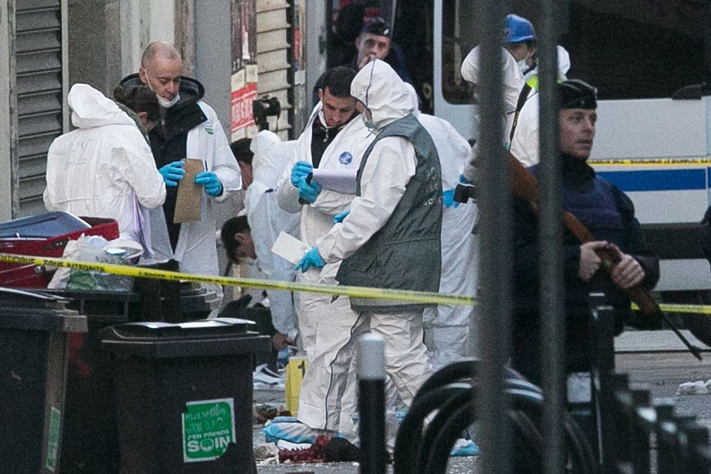 Forensics of the French police near the apartment where the raid was conducted