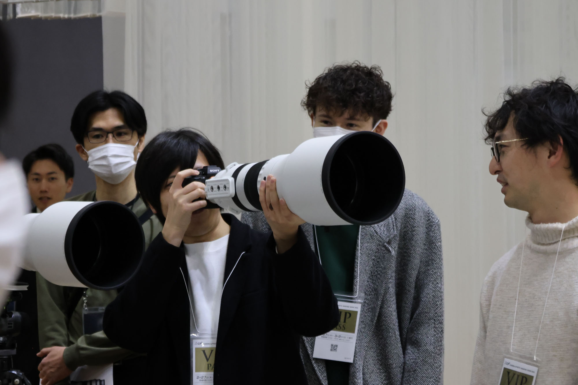 Person holding the Sigma 300-600mm F4 lens at the CP+ 2025 photography show