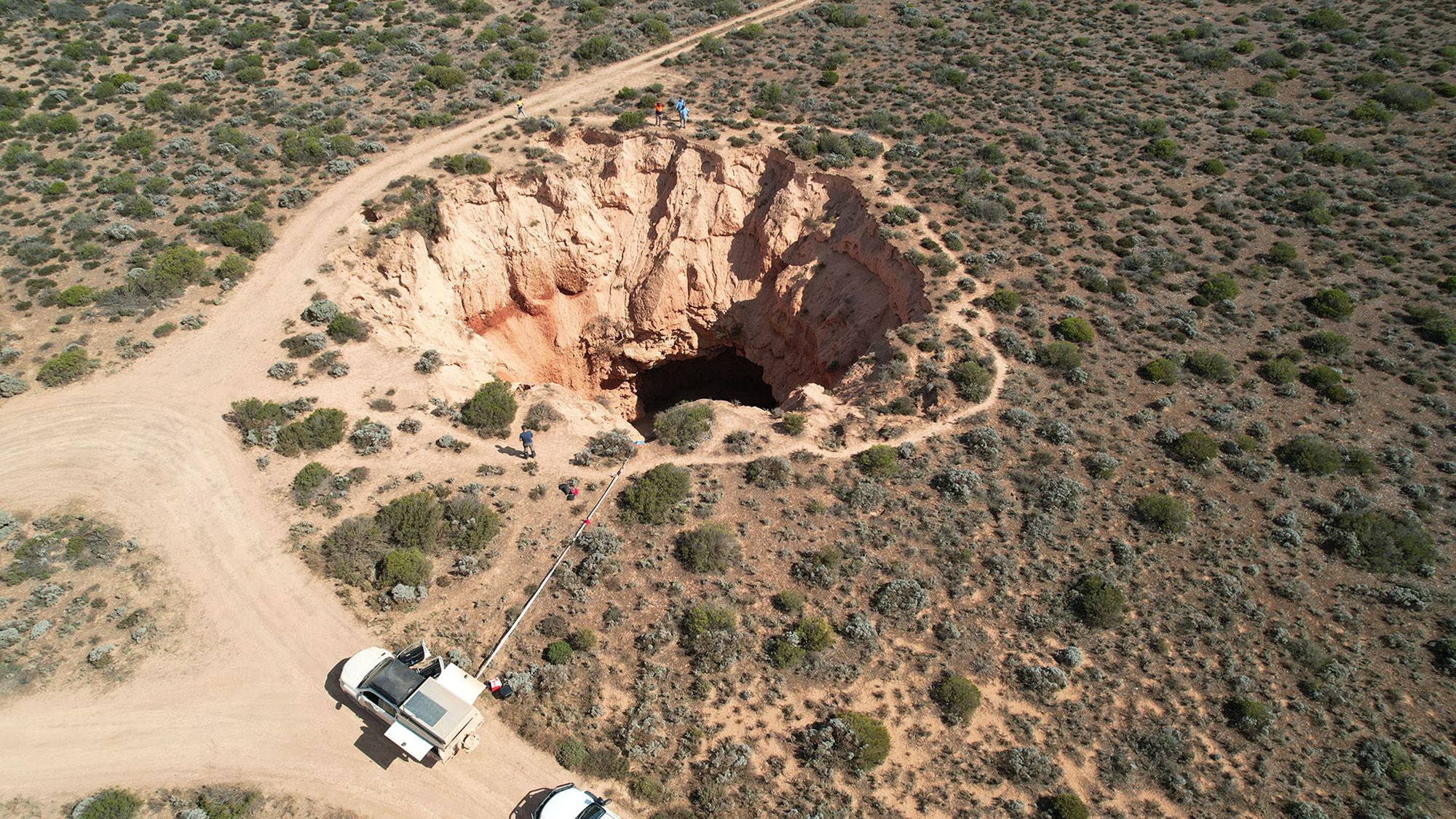 Giant caves beneath sinkhole reveal origin of mystery trenches that score Australia’s Nullarbor Plain