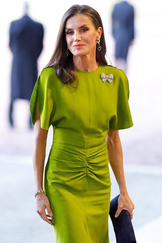 Queen Letizia wearing a bright green dress