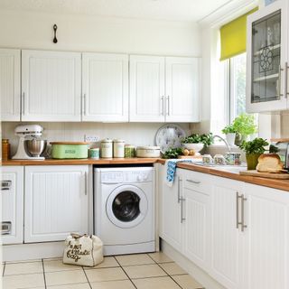 white kitchen with washing machine built into cabinetry