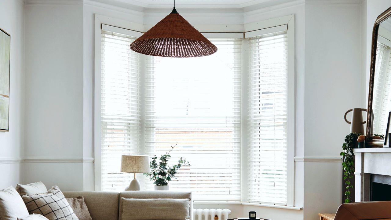 Netural coloured living room with big windows and white blinds