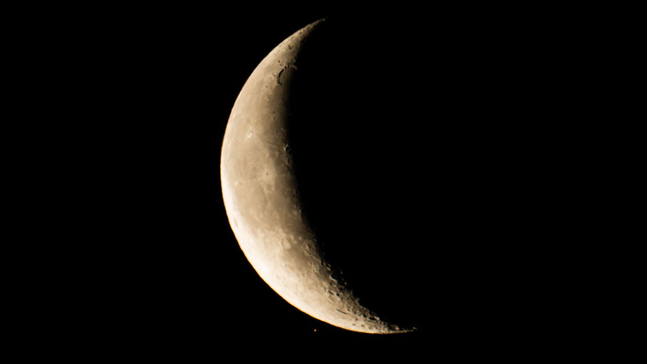 Mars begins to disappear behind the crescent moon at the beginning of the occultation on Feb. 18, 2020. Astrophotographer B.G. Boyd captured this view from Tucson, Arizona.