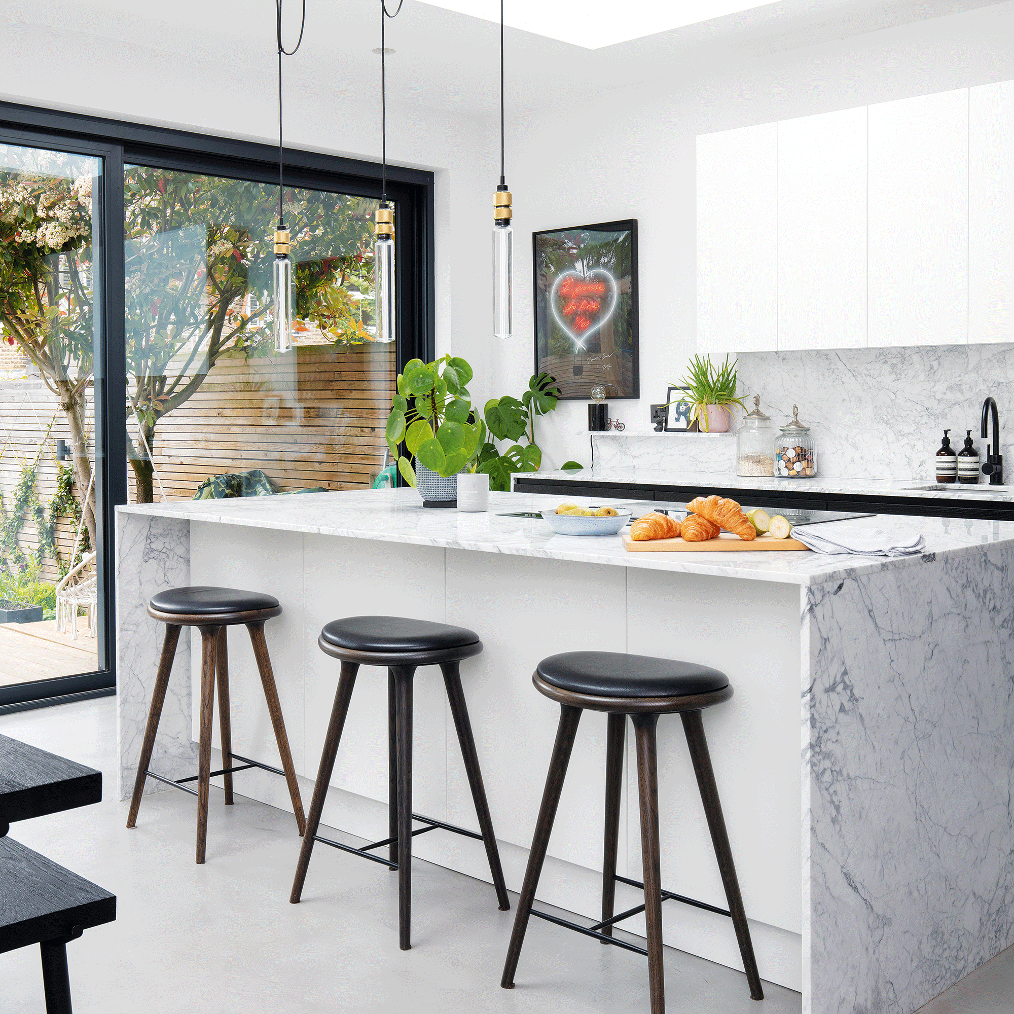 White kitchen with navy stools